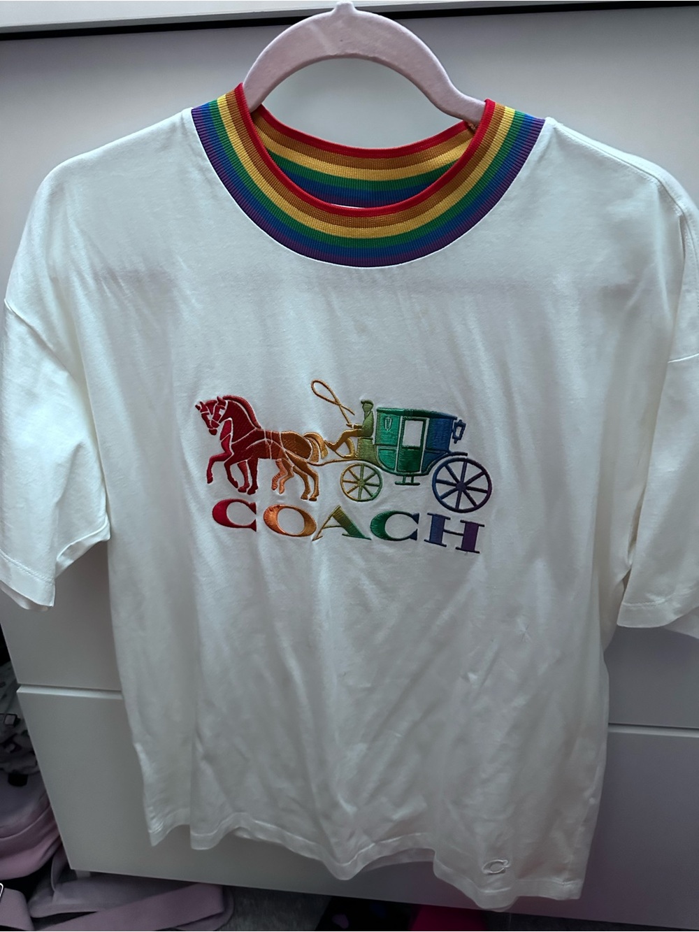 Coach Pride White Tee with Rainbow Carriage Logo and Striped Neck